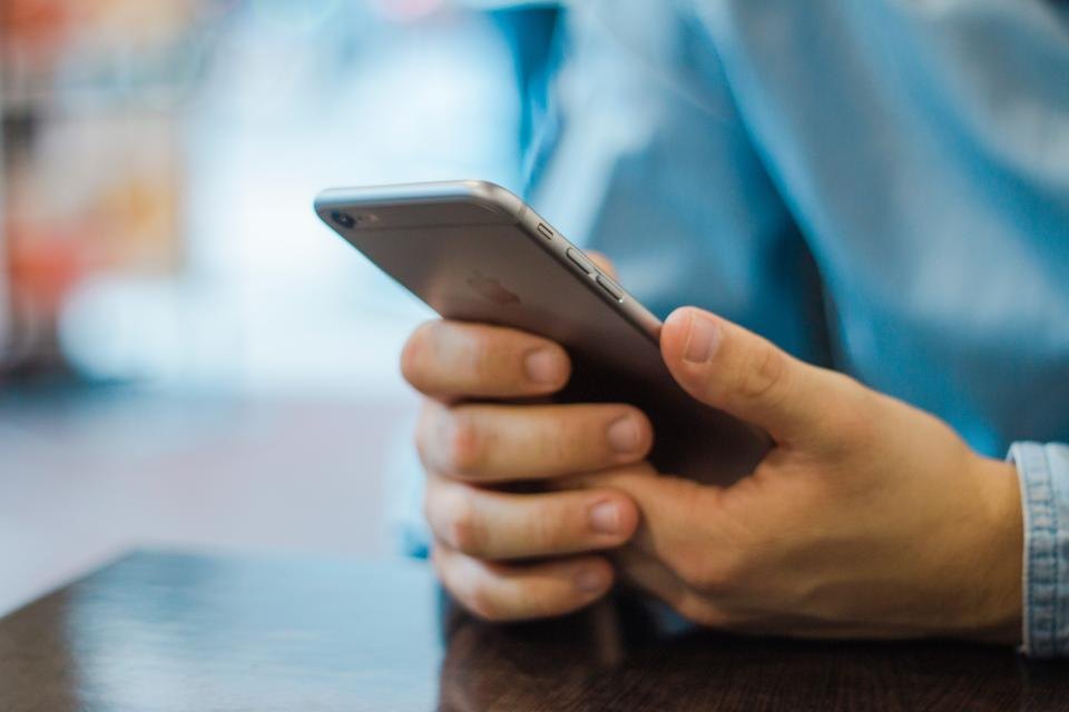 Customer texting on a smartphone, the kind of conversation an AI chatbot can handle for a service business