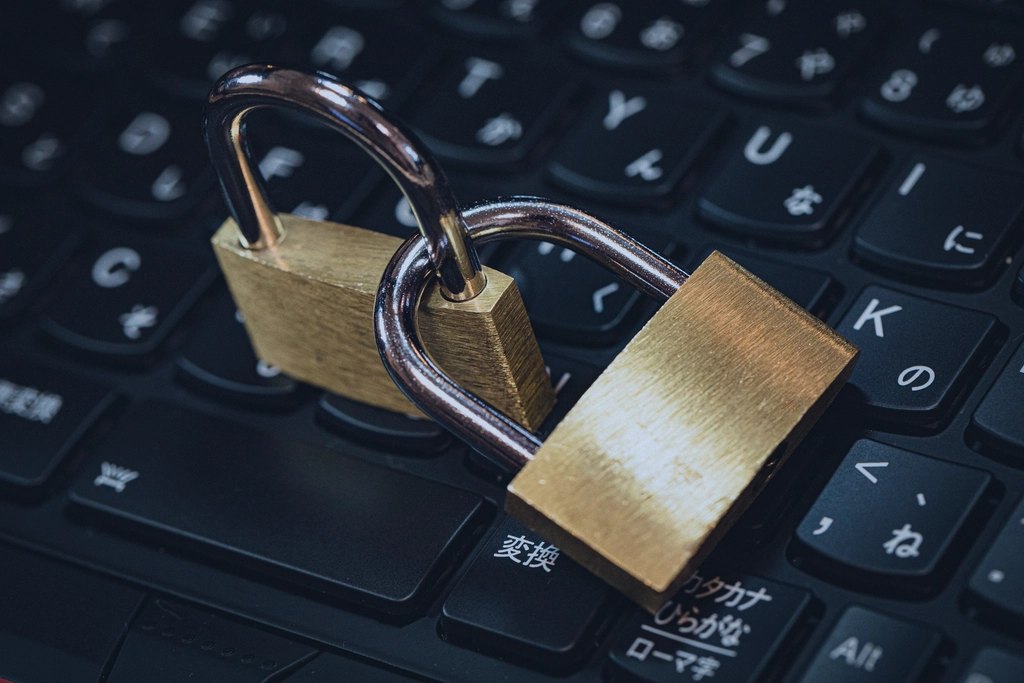 Padlocks resting on a laptop keyboard, representing customer data security