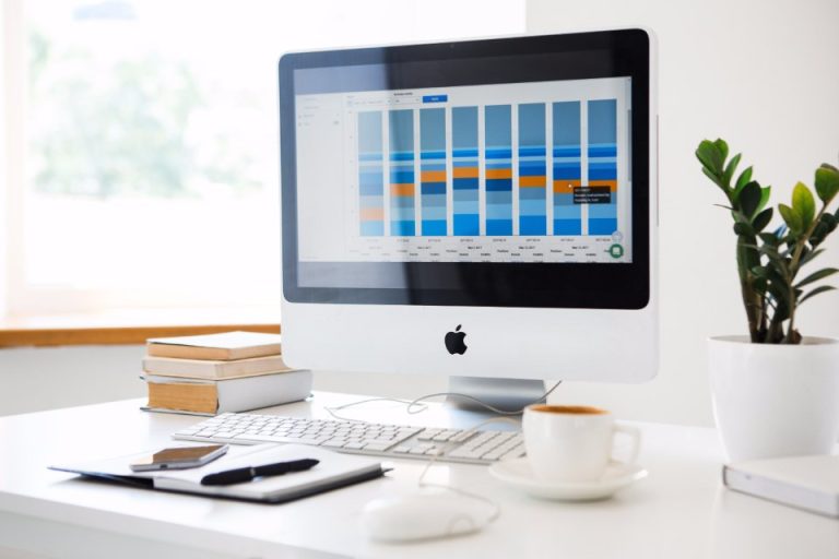 Desktop computer showing a business dashboard in a bright office
