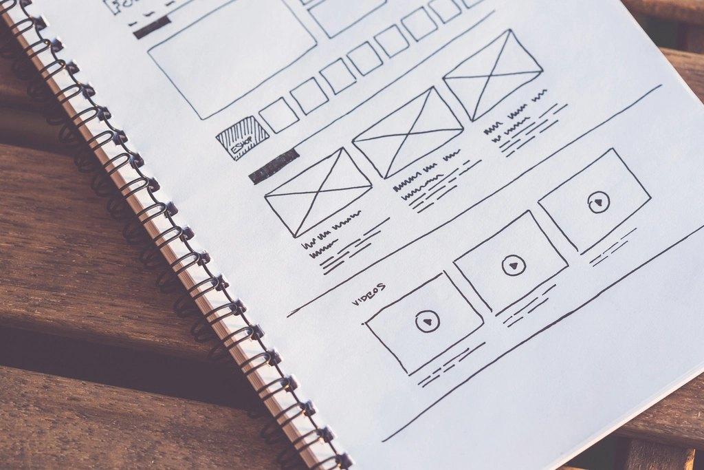 Website wireframe sketches in a spiral notebook