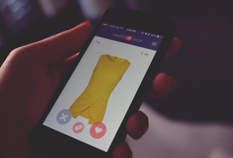 Hand holding a smartphone with a mobile app open