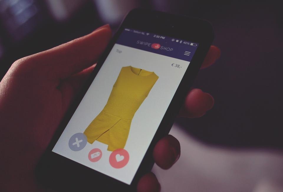 Hand holding a smartphone with a mobile app open