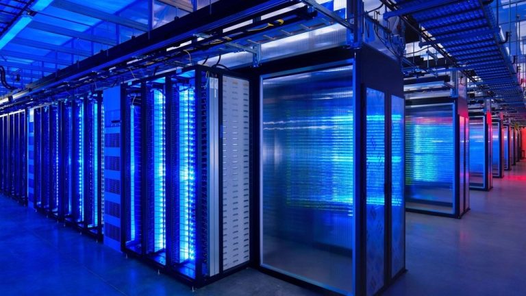Rows of servers glowing blue in a data center