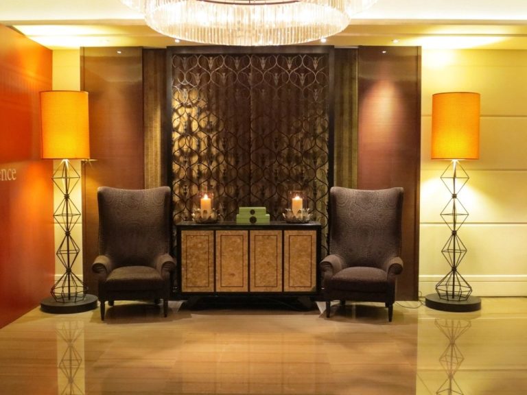 Elegant hotel lobby with armchairs and warm lighting