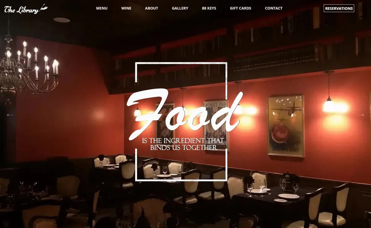 The Library homepage hero showing the dining room, top navigation and a boxed Reservations button